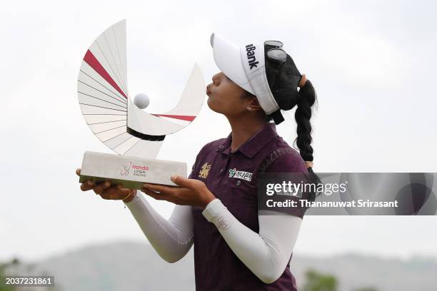 Patty Tavatanakit of Thailand poses with The Honda LPGA Thailand trophy after victory in the final round of the Honda LPGA Thailand at Siam Country...