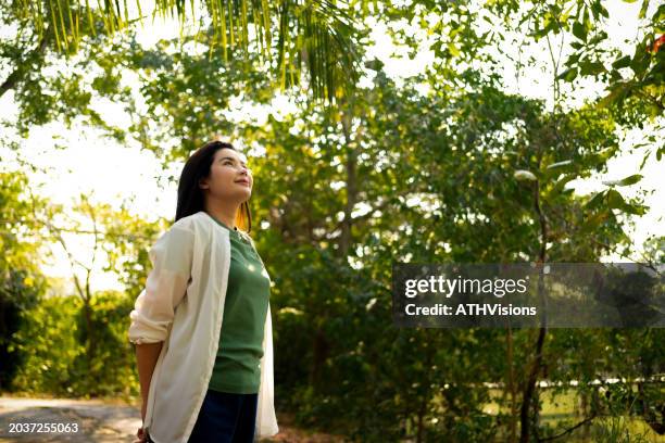 dreamy woman enjoying peaceful forest ambiance - ambiance girly stock pictures, royalty-free photos & images