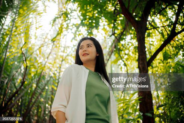 dreamy woman enjoying peaceful forest ambiance - ambiance girly bildbanksfoton och bilder