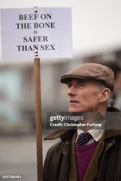 Farmer holds a placard reading "Beef on the bone is safer than sex" outside the Senedd on February 28, 2024 in Cardiff, Wales. Following peaceful...