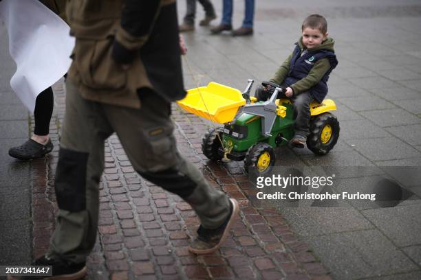 Child is pulled along on a toy tractor during protests outside the Senedd on February 28, 2024 in Cardiff, Wales. Following peaceful demonstrations...