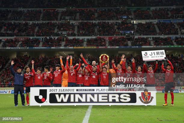 Captain Hisato Sato of Nagoya Grampus lifts the J1 Promotion Play-Off Winners plaque at the award ceremony following the J.League J1 Promotion...