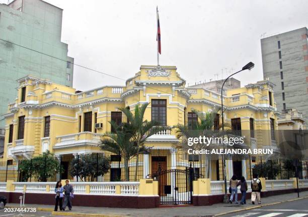 Pedestrians walk in front of the Venezuelan Embassy in Lima 29 June, 2001. Peru has recalled its ambassador from Venezuela, Prime Minister Javier...