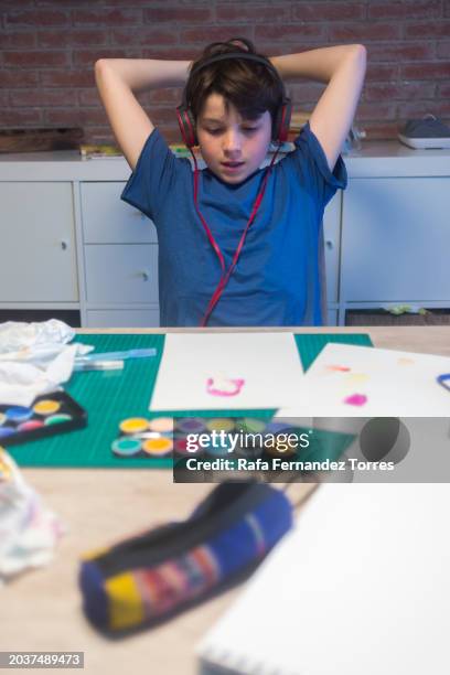 beginner artist listening music with headphones while stretching - art torres stock pictures, royalty-free photos & images
