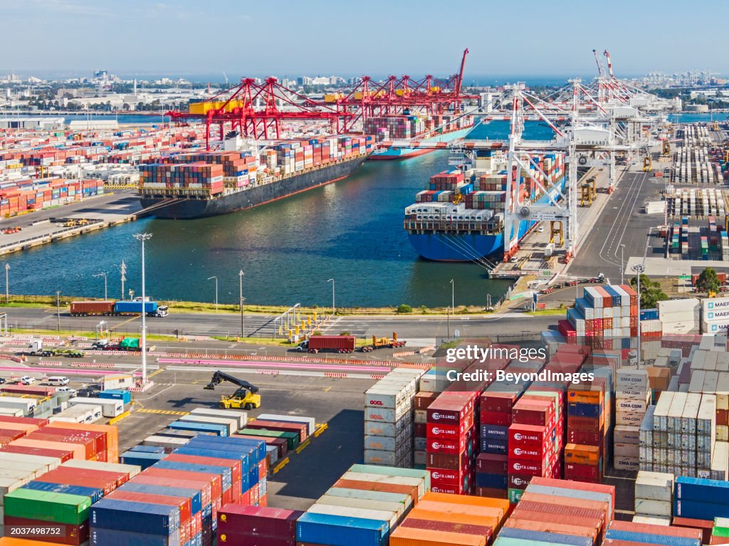 Aerial view busy Port of Melbourne Swanson Dock shipping container terminal, industrial area.