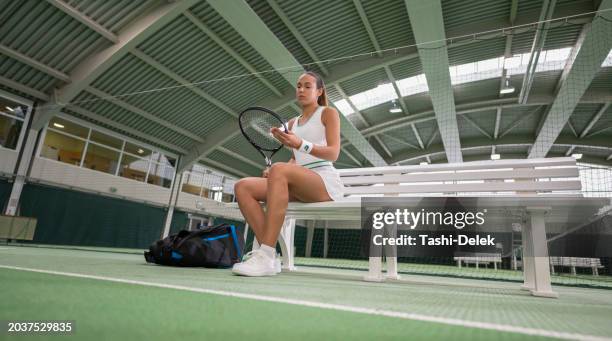 female tennis player sitting on bench - hardcourt stock pictures, royalty-free photos & images
