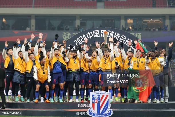 Players of Shanghai Shenhua celebrate with the champion trophy after winning the 2024 Chinese Football Association Super Cup against Shanghai Port at...