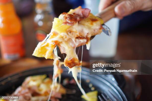 pizza hawaiian on top bacon ham, pineapple and sauce - hawaiian pizza stock pictures, royalty-free photos & images