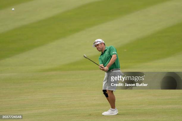Louis Oosthuizen of South Africa pitches onto the green on hole 7 during the final round of the International Series Oman at Al Mouj Golf on February...
