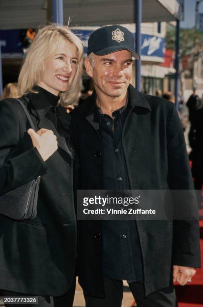 American actress Laura Dern and American actor Billy Bob Thornton, each wearing a black jacket over a black shirt, with Thornton wearing an 'Arkansas...