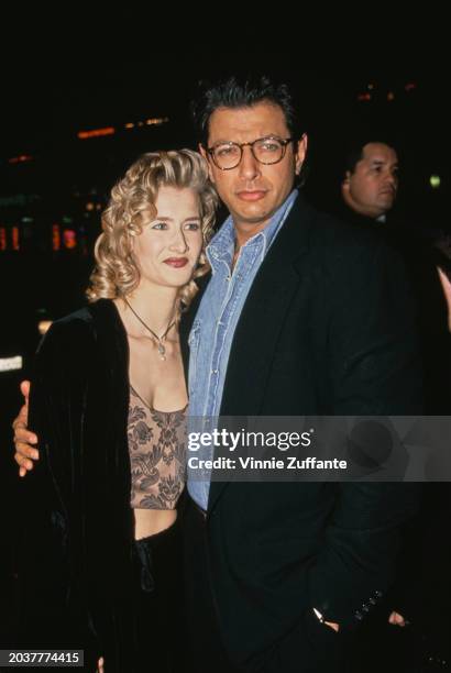 American actress Laura Dern, wearing a black jacket over a cropped top, and American actor Jeff Goldblum, who wears a black jacket over a denim...