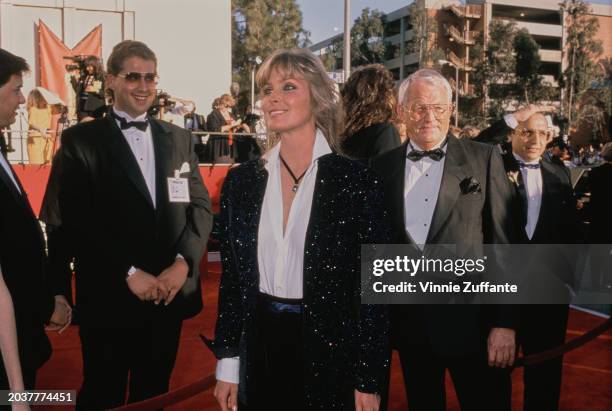 American actress Bo Derek, wearing a sparkling black jacket over a white blouse with an open collar, attends the 61st Academy Awards, held at the...