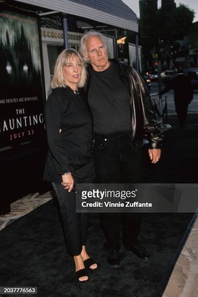 American actor Bruce Dern, wearing a leather jacket over a black top with black trousers, and his wife, Andrea Beckett, similarly dressed in black,...