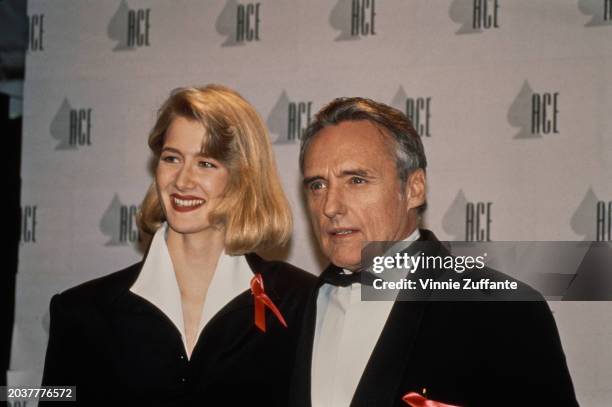 American actress Laura Dern, wearing a white wide-collar shirt beneath a black jacket, and American actor and film director Dennis Hopper, who wears...