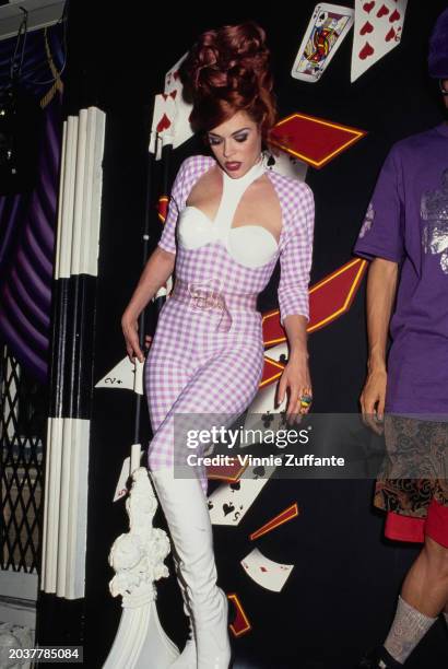 American singer, songwriter and DJ Lady Miss Kier, of American dance band Deee-Lite, wearing a white-and-lilac checked outfit with a keyhole neckline...
