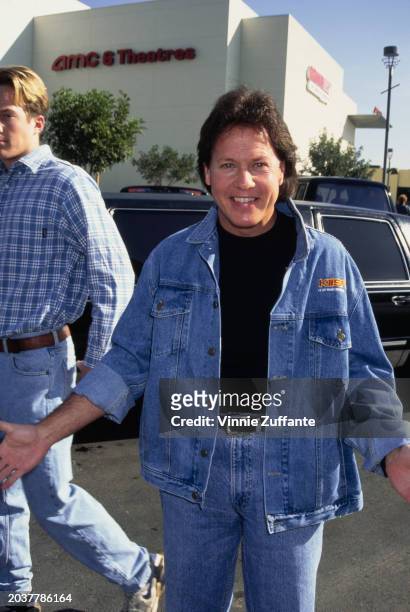 American radio host, comedian and actor Rick Dees, wearing a denim jacket, on which is the logo of KIIS-FM, with the AMC 6 Theatres in the...