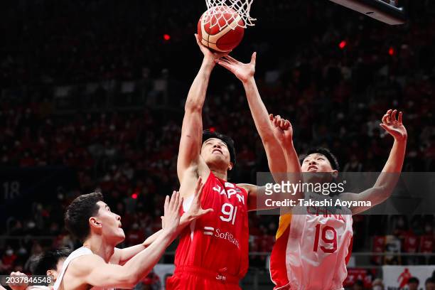 Hirotaka Yoshii of Japan competes for a rebound against Abudushalamu Abudurexiti and Yongxi Cui of China during the FIBA Basketball Asia Cup...