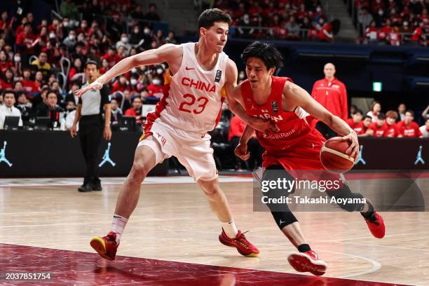 Hirotaka Yoshii of Japan drives to the basket against Abudushalamu Abudurexiti of China during the FIBA Basketball Asia Cup qualifier Group C game...