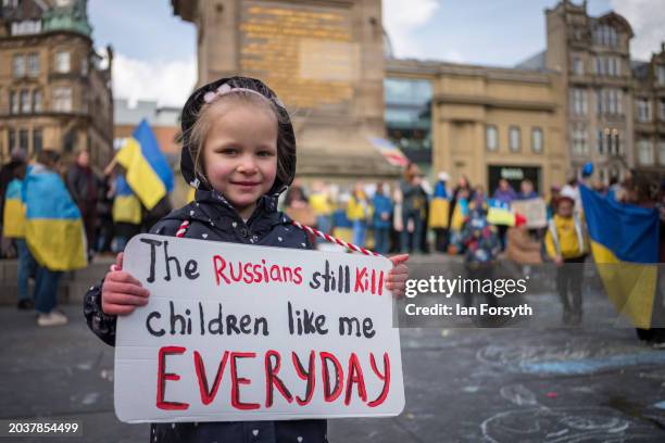 Young girl stands with a home made placard as she attends a rally in Newcastle to mark the two year anniversary of the Russian invasion of Ukraine on...