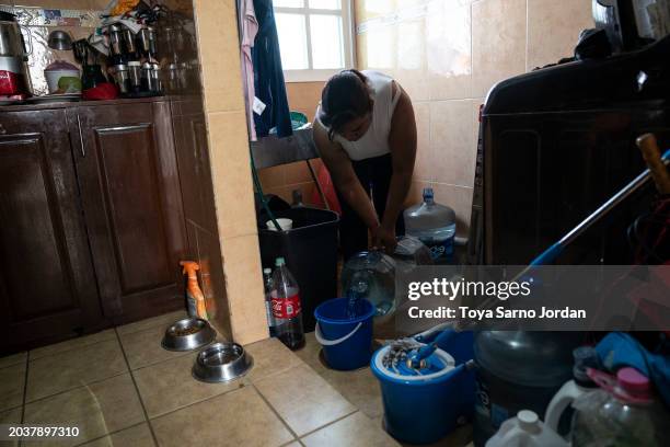 Woman fills a bucket with bottled water at an apartment unit in the Las Peñas neighborhood in Iztapalapa on February 27, 2024 in Mexico City, Mexico....