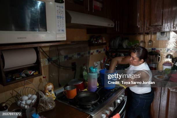 Woman washes dishes with bottled water at an apartment complex in the Las Peñas neighborhood in Iztapalapa on February 27, 2024 in Mexico City,...