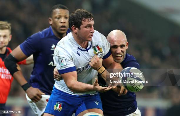 Michele Lamaro of Italy offloads the ball whilst being tackled by Maxime Lucu of France during the Guinness Six Nations 2024 match between France and...