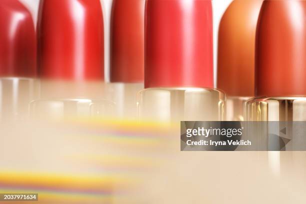 set of red beige pale brown pink lipstick lip in golden silver glossy tube  on gray color background with reflection. - silver lipstick stock pictures, royalty-free photos & images