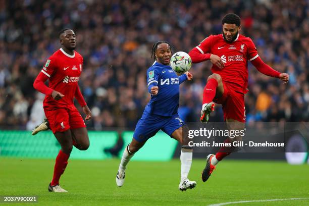 Raheem Sterling of Chelsea battles for possession with Joe Gomez and Ibrahima Konate of Liverpool during the Carabao Cup Final match between Chelsea...