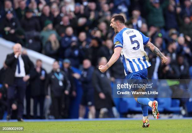 Lewis Dunk of Brighton celebrates scoring his team's first goal during the Premier League match between Brighton & Hove Albion and Everton FC at...