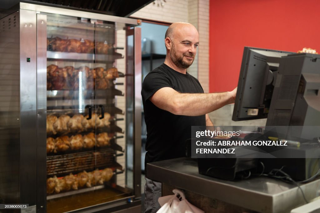 Employee in rotisserie working at the checkout