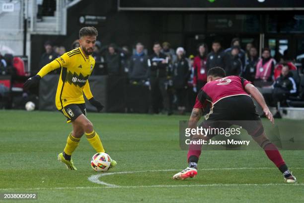 Diego Rossi of the Columbus Crew dribbles the ball while Derrick Williams of the Atlanta United FC defends during the second half at Lower.com Field...