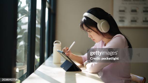 teenager working on digital tablet. - chinese tutor study stock pictures, royalty-free photos & images