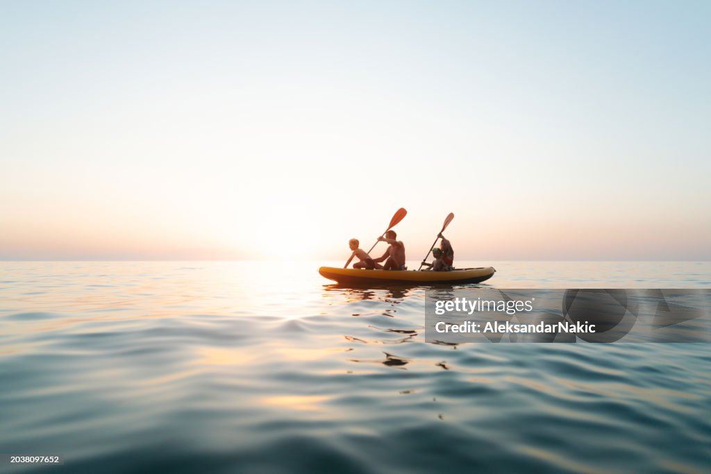 Family paddling on the ocean