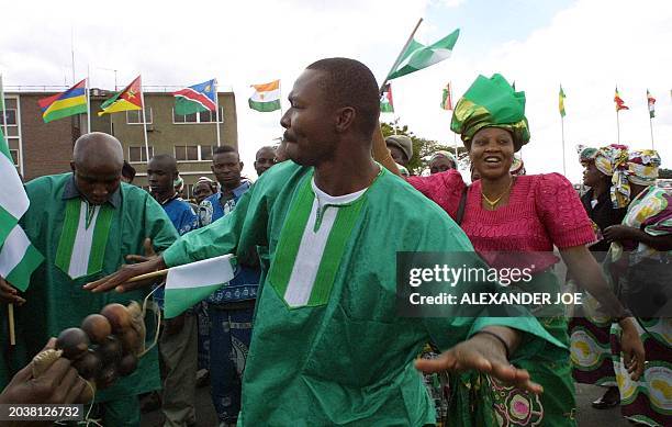 Nigerian and Zambian sing and dance as some of the African leaders arrive at Lusaka International Airport 08 July to attend the 37th Organisation of...