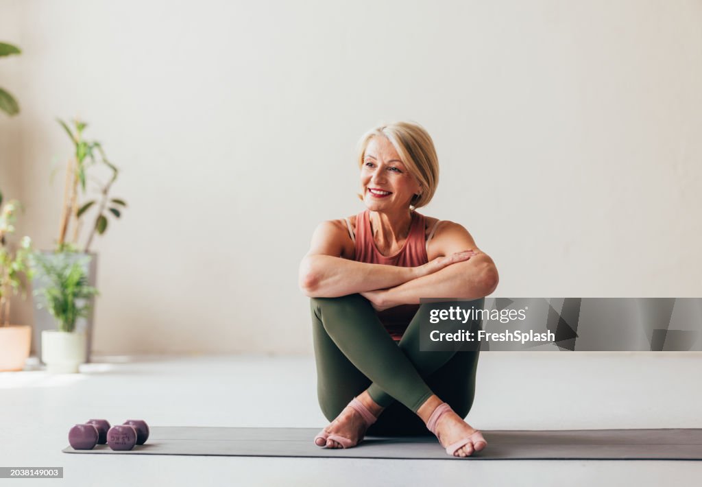 Senior Woman Smiling During Yoga Practice in a Peaceful Home Environment