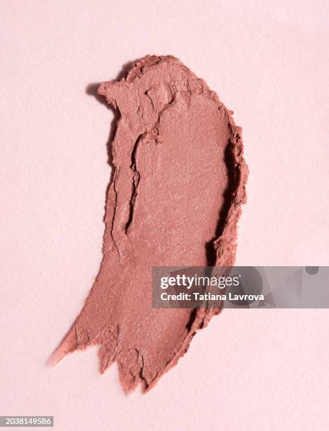 beige pastel colored lipstick swatch on trendy pink background. fashion, beauty products industry. macro photography, top view, close up - pink lipstick smear stock pictures, royalty-free photos & images