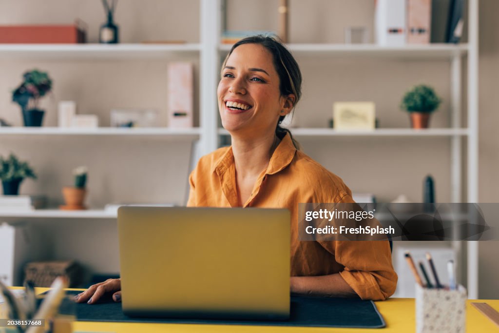 Happy Professional Woman Enjoying Her Workday at a Sunny Office Desk