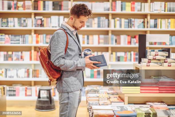 young man shopping books - bookshop stock pictures, royalty-free photos & images