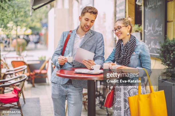 young couple shopping in a coffee shop - hungarian ethnicity stock pictures, royalty-free photos & images