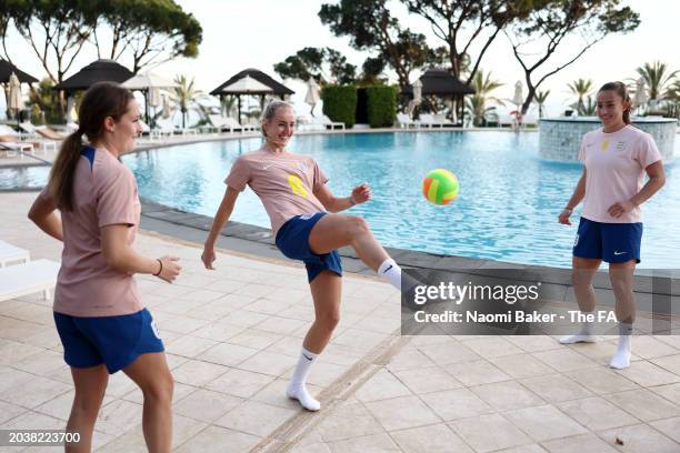 Maya Le Tissier, Millie Turner and Ella Toone of England pass a ball at La Quinta Football Center on February 21, 2024 in Marbella, Spain.