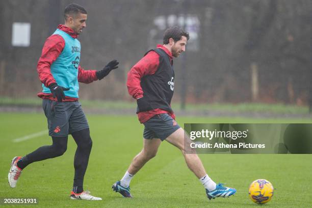 Kyle Naughton pressures Joe Allen of Swansea City during the Swansea City AFC Training Session at Fairwood Training Ground on February 28, 2023 in...