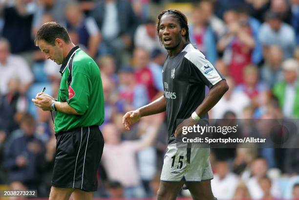 Didier Drogba of Chelsea is booked by Referee Rob Styles during the Premier League match between Aston Villa and Chelsea at Villa Park on September...