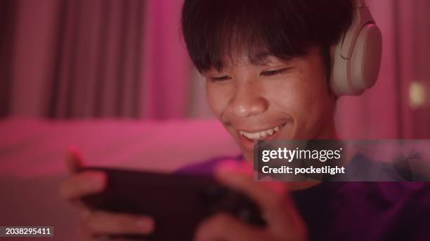 teenage having fun with game on smartphone. - mobile game stock pictures, royalty-free photos & images