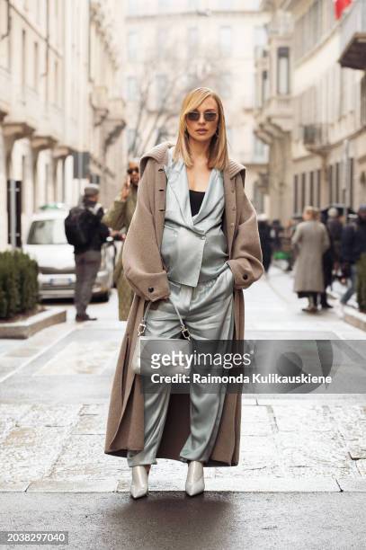 Viky Rader wears a mint green or pale blue silk suit, beige coat, white bag, and white pointy outside Giorgio Armani during the Milan Fashion Week -...