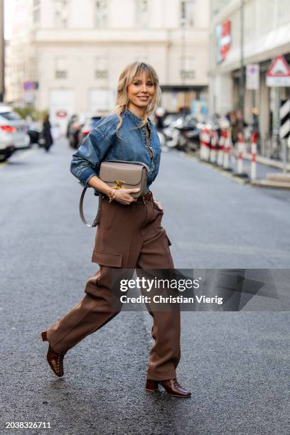 Ekaterina Mamaeva wears denim shirt Chloe, brown pants Peter Do, shoes By Far, grey bag Celine, earrings By Pariah, necklace Tiffany & Co outside...