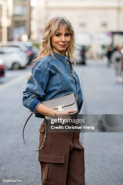 Ekaterina Mamaeva wears denim shirt Chloe, brown pants Peter Do, grey bag Celine, earrings By Pariah, necklace Tiffany & Co outside during the Milan...