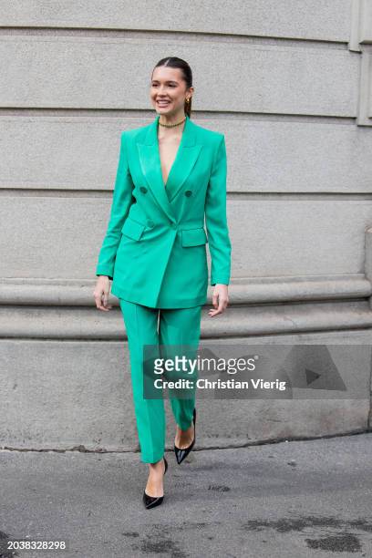 Guest wears green suit outside Luisa Spagnoli during the Milan Fashion Week - Womenswear Fall/Winter 2024-2025 on February 25, 2024 in Milan, Italy.