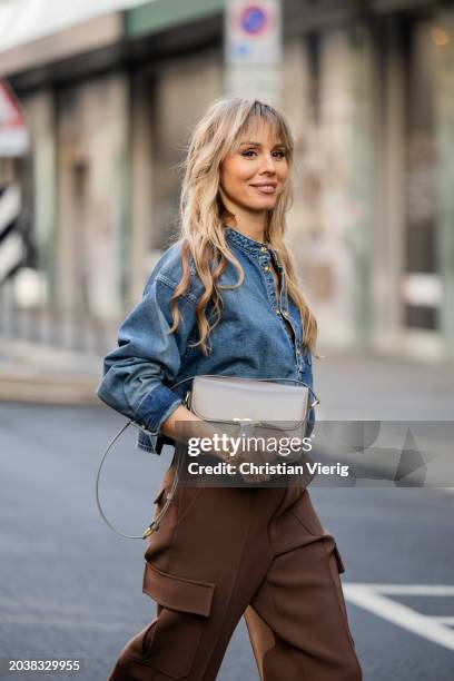 Ekaterina Mamaeva wears denim shirt Chloe, brown pants Peter Do, grey bag Celine, earrings By Pariah, necklace Tiffany & Co outside during the Milan...