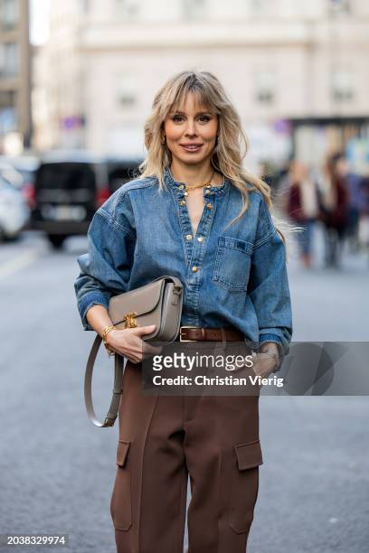 Ekaterina Mamaeva wears denim shirt Chloe, brown pants Peter Do, grey bag Celine, earrings By Pariah, necklace Tiffany & Co outside during the Milan...