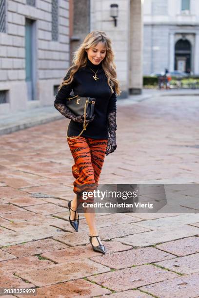 Ekaterina Mamaeva wears black pullover Raey, rust brown skirt Anine Bing, heels The Row, bag Celine, necklace Chloe, transparent laced gloves...